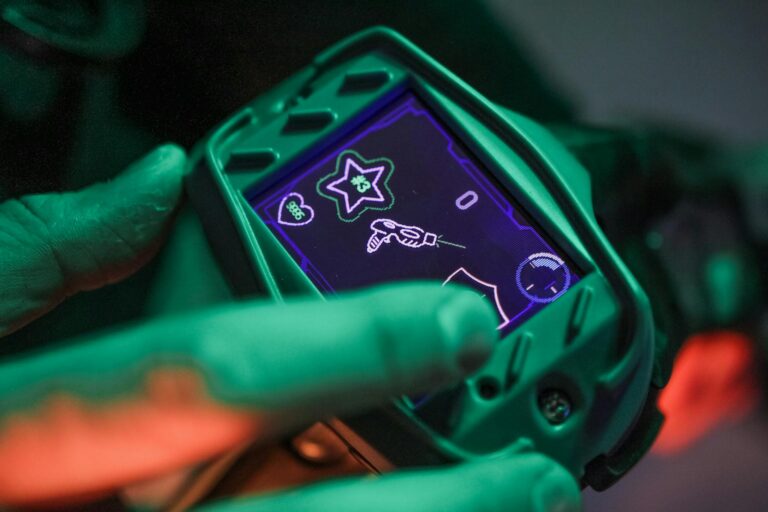 A close-up view of a laser tag device screen during a game session indoors.